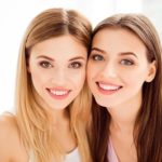 Dental Veneers vs. Lumineers 10 Close up portrait of two girls smiling