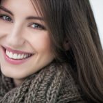 Beautiful smiling woman wearing a warm woolen scarf