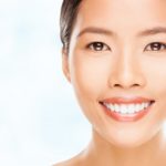 How Sugar Affects Your Teeth and Gums 7 Portrait of a beautiful young Asian woman smiling