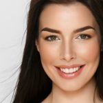10 Ways to Help Prevent Cavities and Promote Optimal Oral Health 2 A young woman smiling
