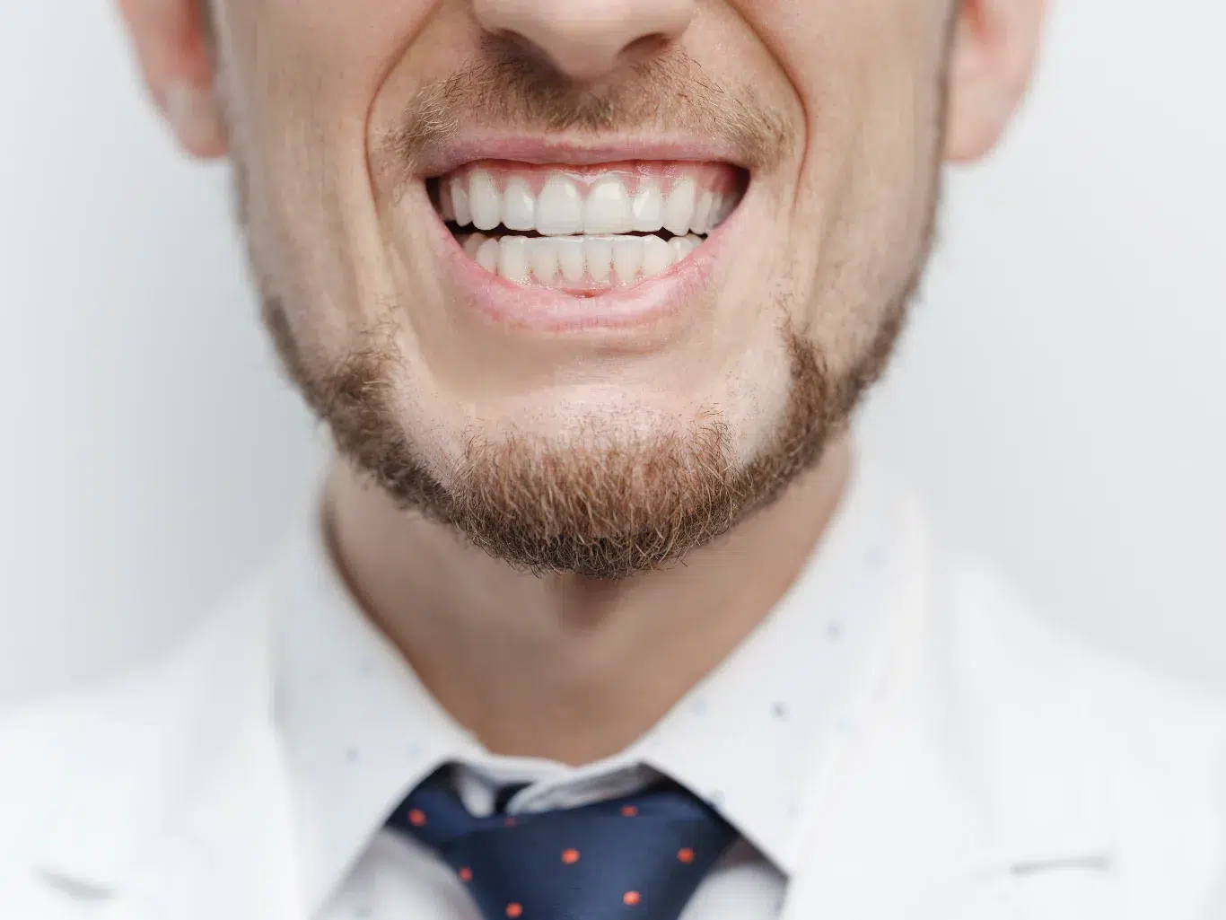 Closeup shot of male mouth with clear aligners on his teeth