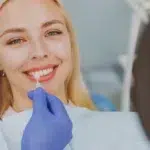 Stop Teeth Grinding at Night: A Guide for Bruxism Relief 2 happy woman choose veneers enamel color compare teeth shade